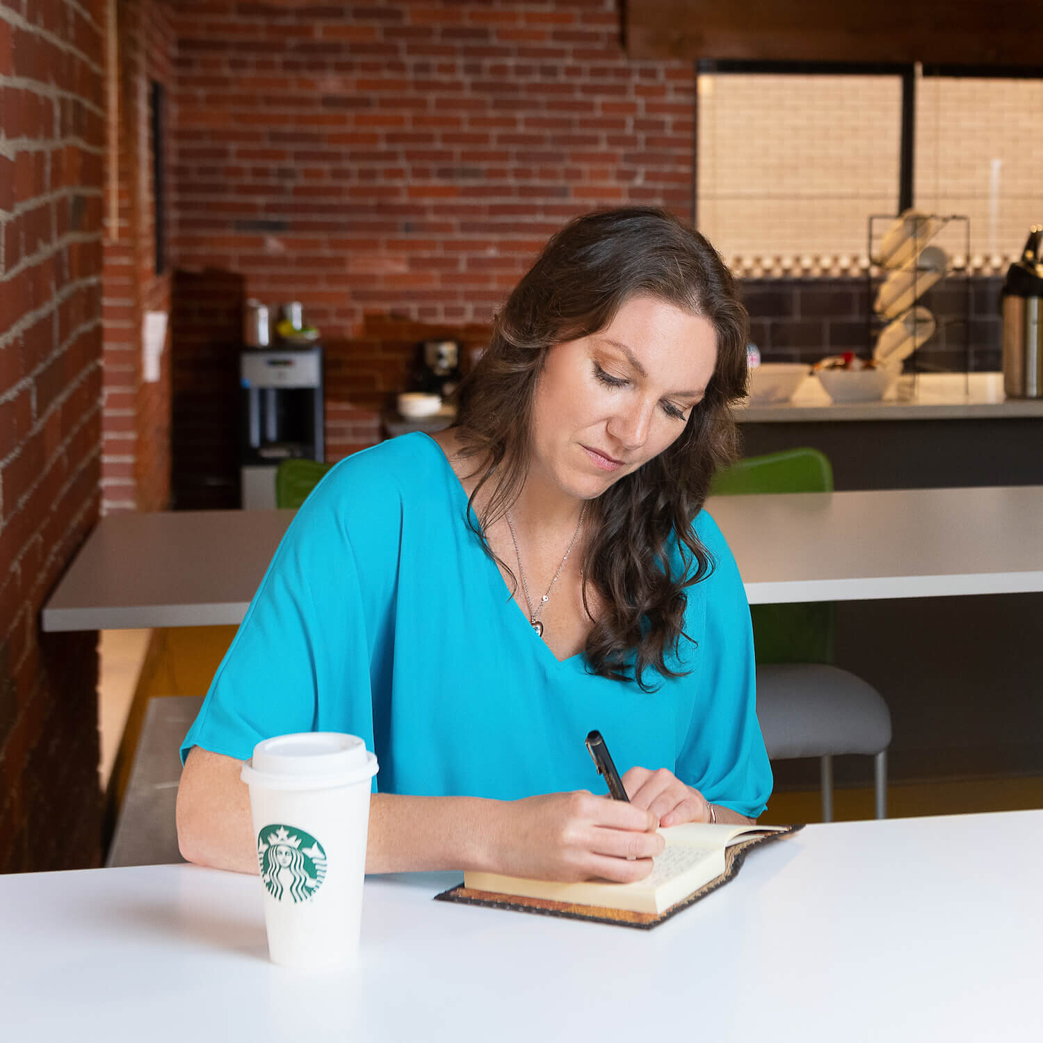 holistic health coach - Elizabeth sitting in coffee shop writing in notebook.jpg